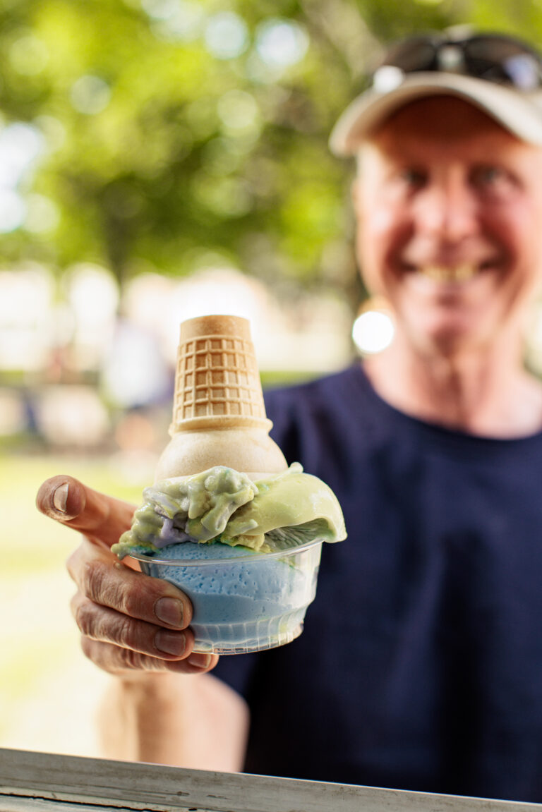 Man holding an ice ream cone in a bowl